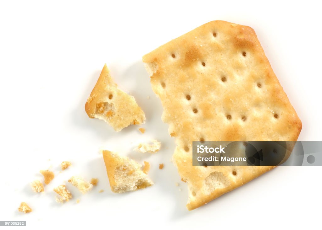 crumbs and pieces of cracker macro pieces and crumbs of cracker macro isolated on white background Cracker - Snack Stock Photo