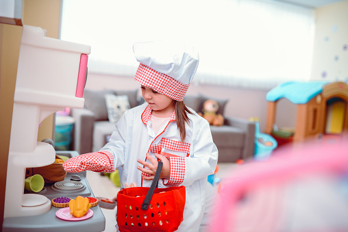 Toddler Girls Playing Cooking Chef with Toys in a Preschool Classroom