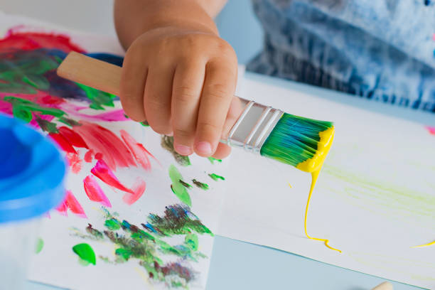istock Brush with paint in the child's hand 841010266