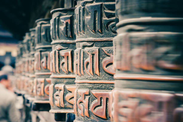 Prayer wheels at  the Swayambunath Temple, Kathmandu, Nepal Three bronze prayer wheels at the Swayambunath Temple, Kathmandu, Nepal prayer wheel nepal kathmandu buddhism stock pictures, royalty-free photos & images