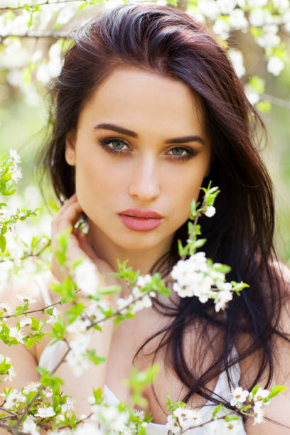 Beautiful girl on the background of blooming trees.