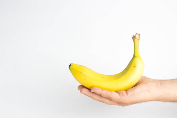 istock Close-up of a hand holding a banana 841018376