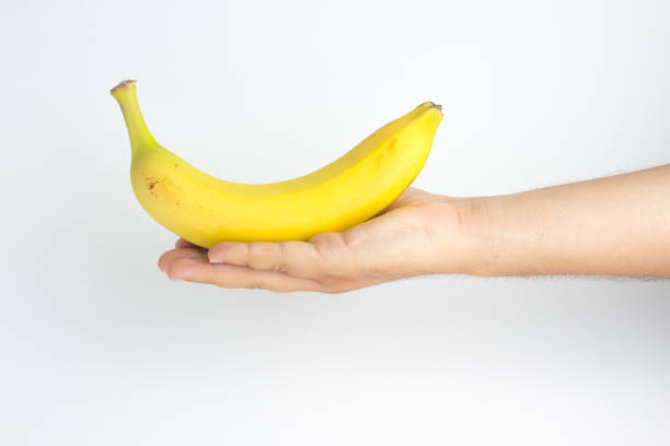 istock Close-up of a hand holding a banana 841018406