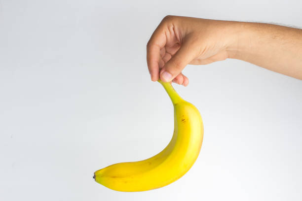 istock Close-up of a hand holding a banana 841018454
