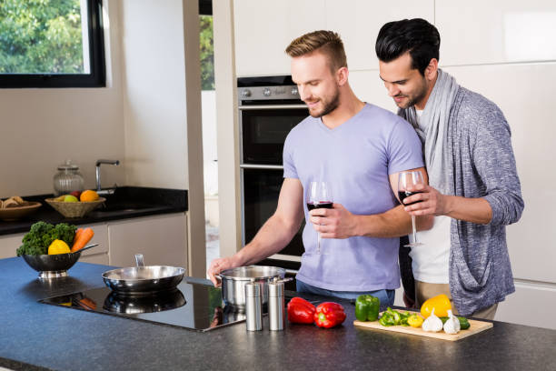 istock smiling gay couple preparing food 841019284