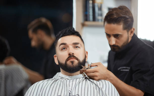 istock Hairstylist working at barbershop cutting bread with scissors 841020004