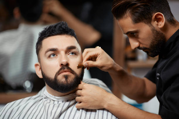 istock Handsome man visiting barbershop for  corection brea 841020396