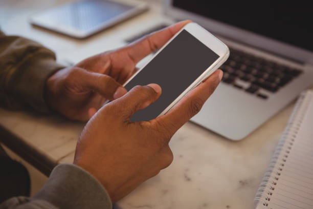 istock Cropped hands of man using phone 841023604