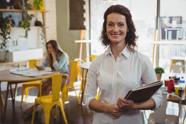 istock Portrait of waitress with menu in cafe 841025940