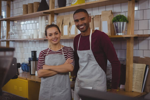 istock Portrait of owners standing in cafe 841026078