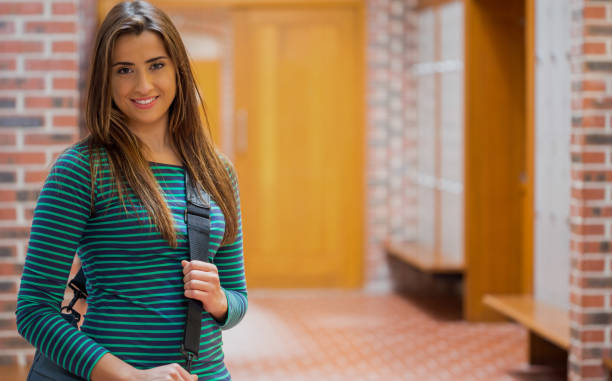 istock Beautiful smiling girl in college corridor 841027358