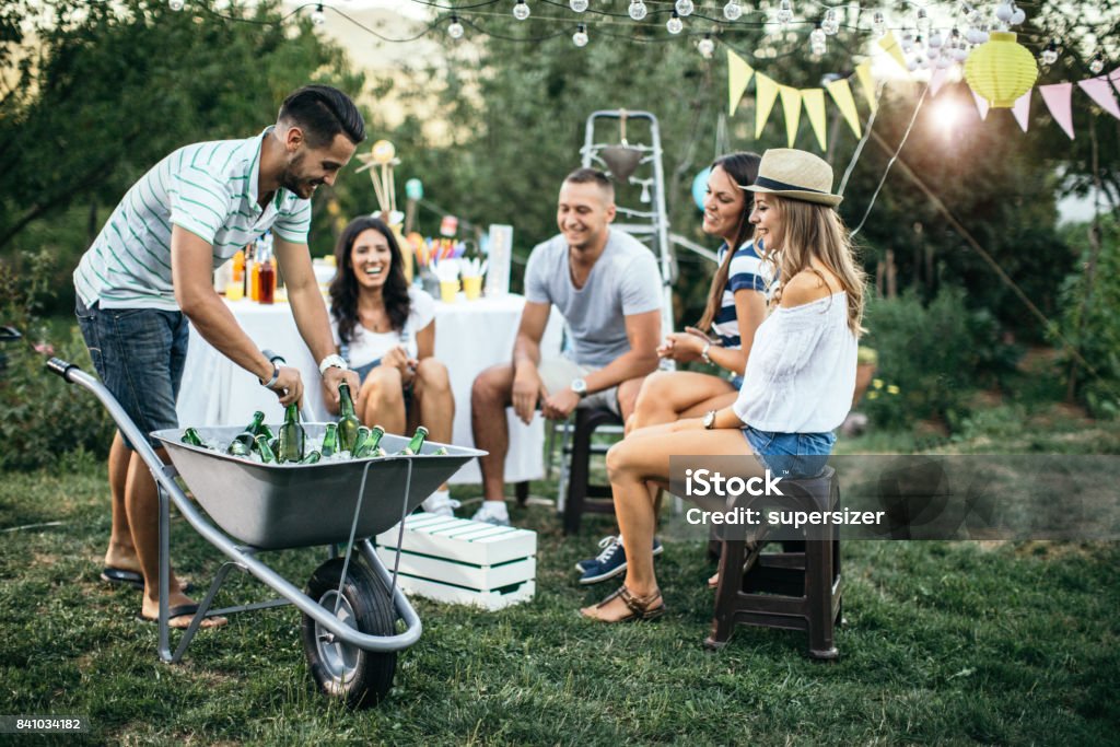 Outdoor party A group of youngsters is having a party outdoor Garden Party Stock Photo