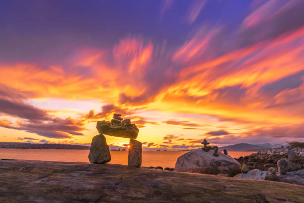 istock rocks balance with fire sunset clouds sky background 841034454