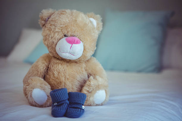 istock View of teddy bear and baby socks 841037946