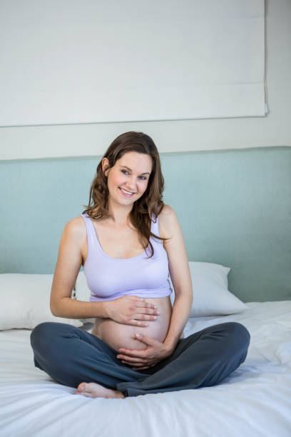 istock Pregnant woman touching her belly 841038012