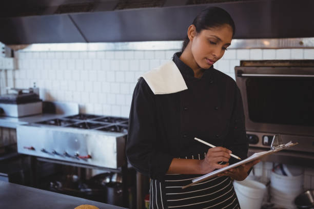 istock Waitress with clipboard in cafe 841038782