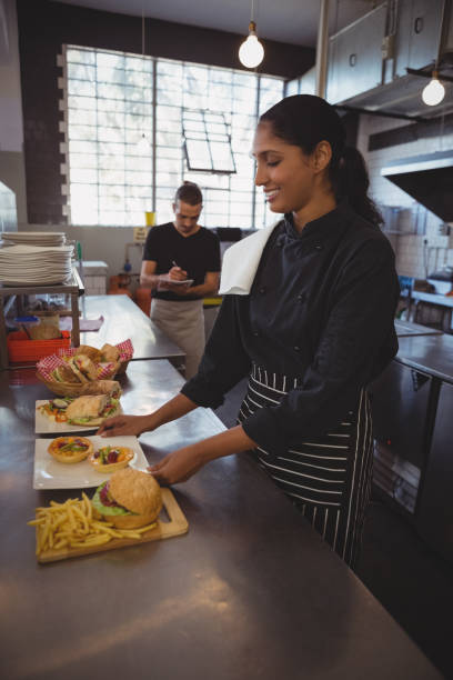 istock Waitress arranging plate with food in cafe 841040268