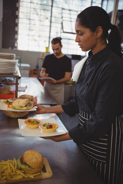 istock Waitress holding plates with food in cafe 841040284