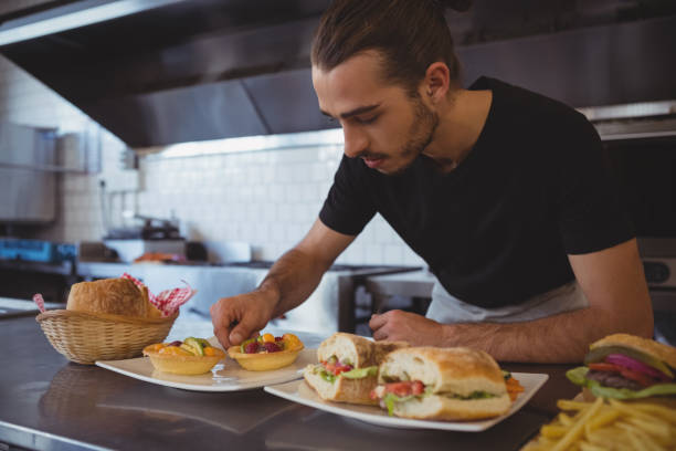 istock Waiter arranging food in plate at cafe 841040310