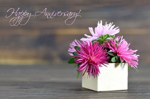 Happy Anniversary card with flowers arranged in gift box