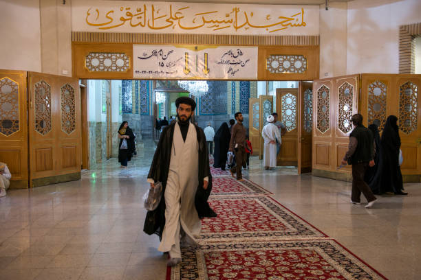 Qom- Iran Qom- Iran. -may 14,2013: Mullah with turban and long robe in the corridors of the Fatima Masumeh shrine. Fatima Masumeh shrine is an important center of religion for sii sect. mullah photos stock pictures, royalty-free photos & images