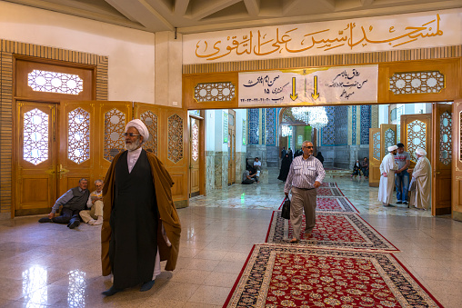 Qom- Iran. -may 14,2013: Mullah with turban and long robe in the corridors of the Fatima Masumeh shrine. Fatima Masumeh shrine is an important center of religion for sii sect.