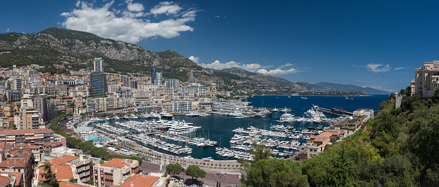 A high level ultra wide angle view of the luxury yachts and buildings of Monaco Monte Carlo Harbour