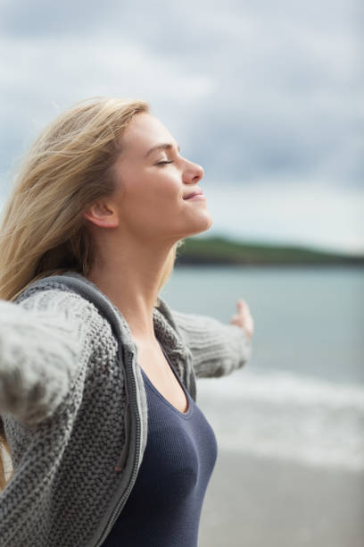 istock Side view of a woman stretching her arms on beach 841044780