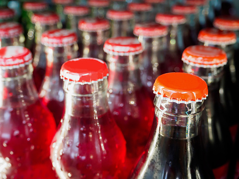 glass bottles with soft drinks background