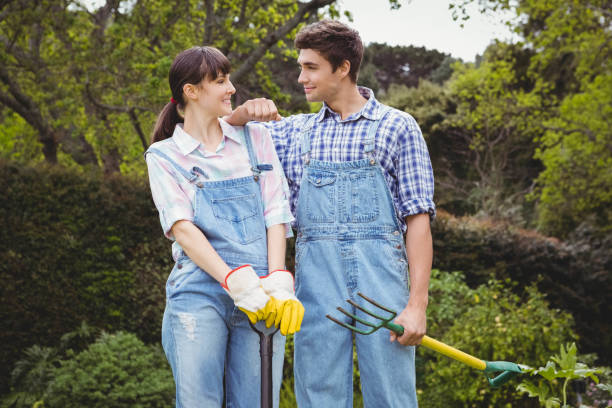 istock Young couple holding shovel and spading fork 841045662