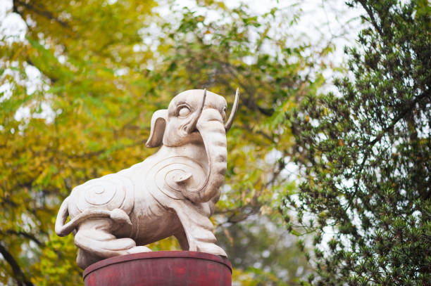White elephant statue against yellow trees in China