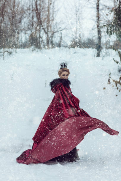 istock Princess in a red cloak in the snow 841048954