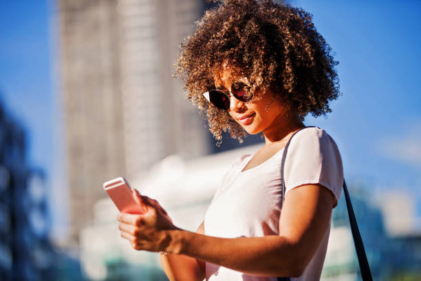 istock Woman with cell phone outdoor 841049054