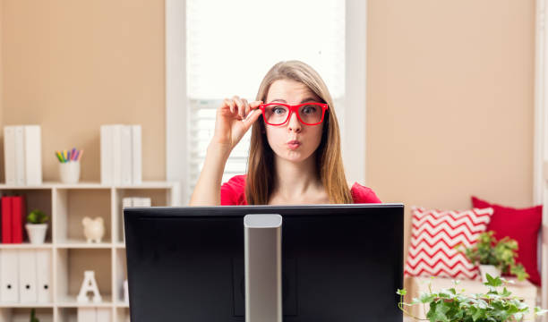 istock Young woman sitting at her desk 841050664