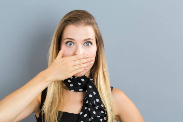 istock Young woman covering her mouth 841050856