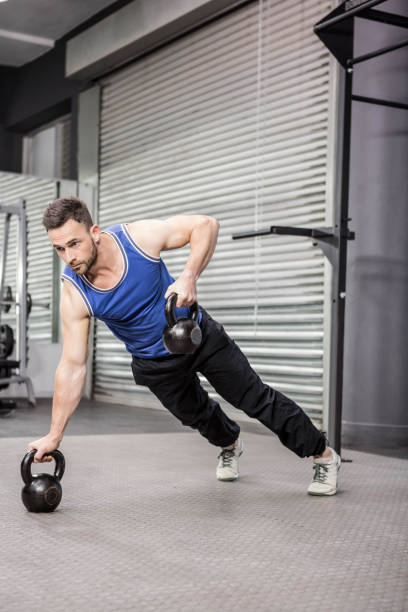 istock Muscular man doing push up with kettlebells 841051086