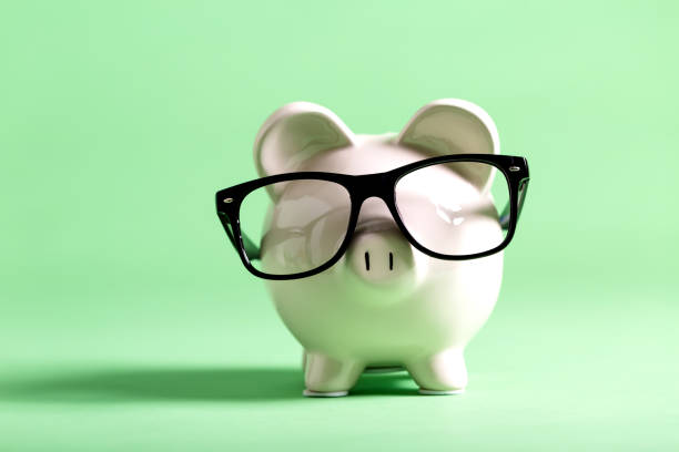 istock White piggy bank on a green background 841053714