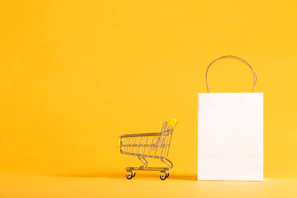 istock Shopping theme with gift bag with shopping cart 841053764