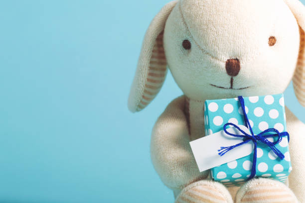 istock Child celebration theme with gift and stuffed animal 841053860