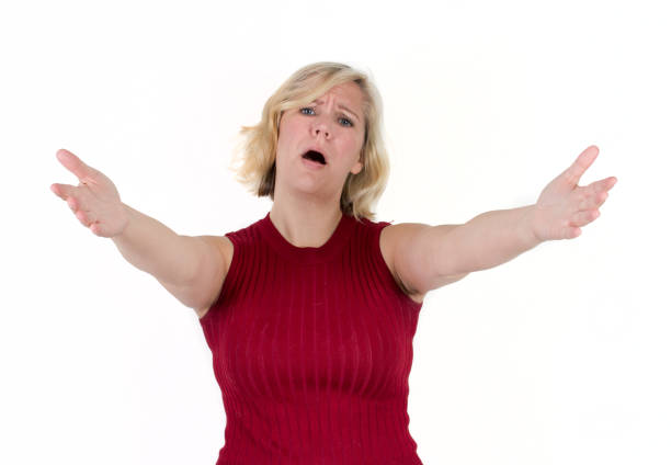 woman with compassionate face and arms outstretched a blond woman in studio background reaches arms and hands out, with a sad or pitying face beckoning photos stock pictures, royalty-free photos & images