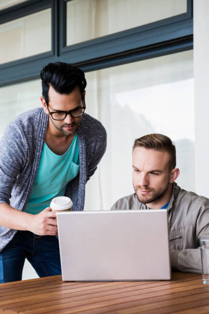istock Focused gay couple using laptop 841054378