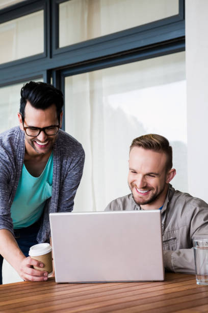 istock Happy gay couple using laptop 841054402