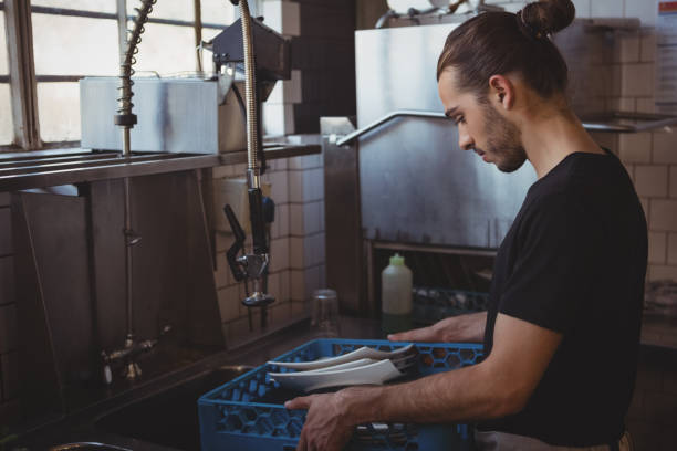 istock Waiter with crate at kitchen sink 841054588