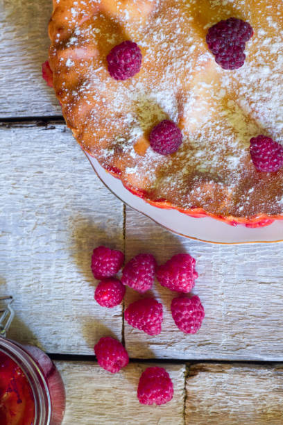 istock Raspberry pie with fresh raspberries and jam on white wooden background. Top view 841065306