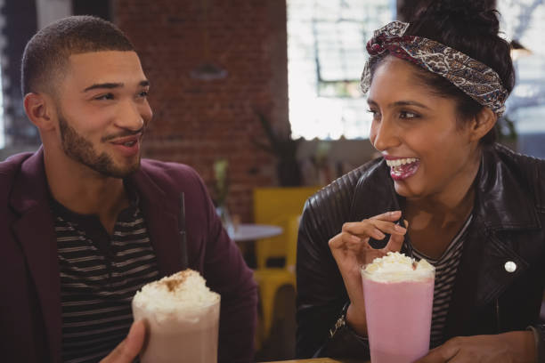 istock Friends enjoying milkshakes in cafe 841069086