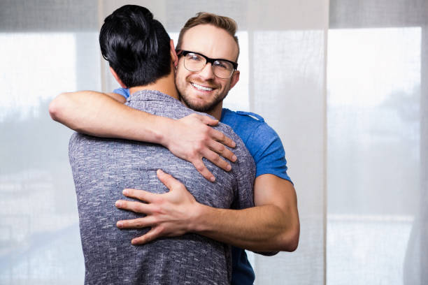 istock Smiling gay couple embracing 841069932