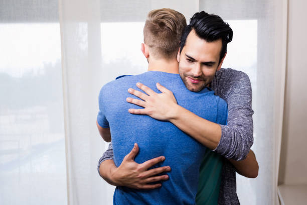 istock Smiling gay couple embracing 841071976