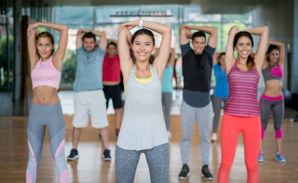 istock Happy group of people in a stretching class at the gym 841074930
