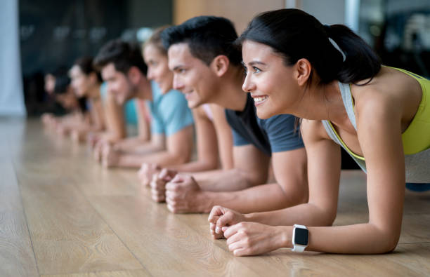 istock Group of people at the gym doing planks 841075182