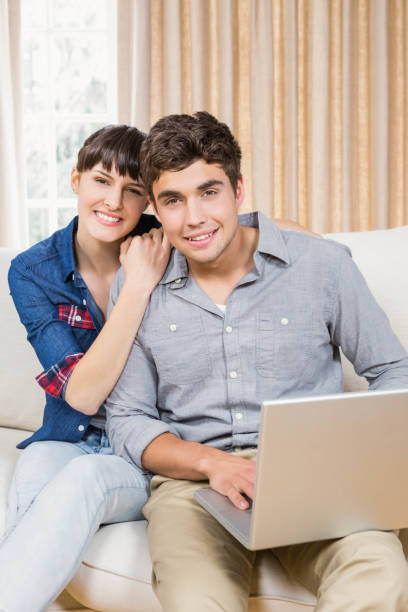 istock Portrait of young couple using a laptop 841083402